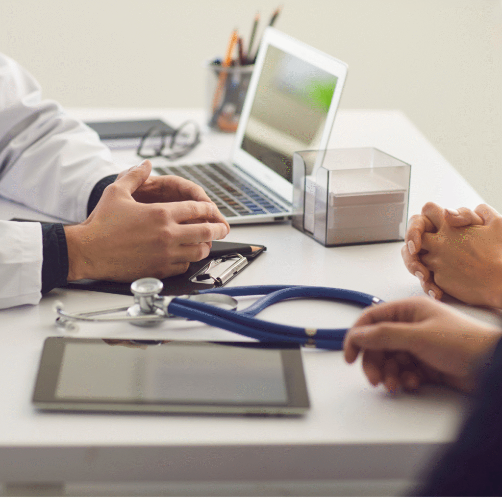 Two patients having a consultation with a physician in their office