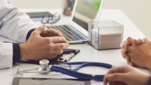 Two patients having a consultation with a physician in their office