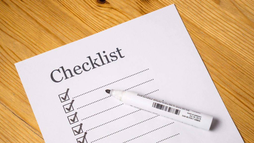 Pen resting on a printed checklist of preparation tasks for a clinical trial screening visit.