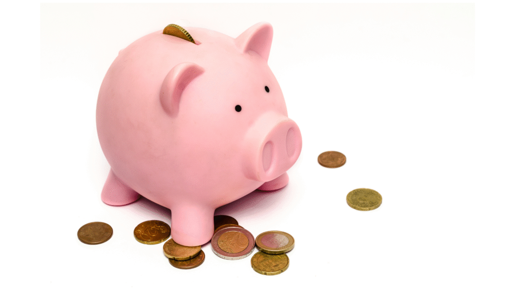Pink piggy bank surrounded by scattered coins symbolizing healthcare savings
